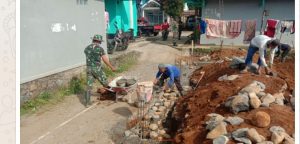 Anggota TNI Bantu Warga Bangun Gedung Serba Guna